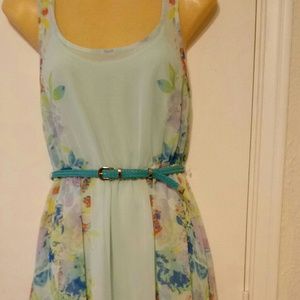 Floral dress of soft teal in color.